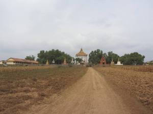Krong Wat, Kampong Cham.  School building to the left, ornate graves and temple central