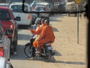 Monks on motorbikes are a common sight in Cambodia