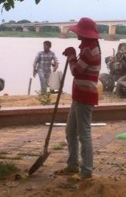 Thongs, jeans, jumper, sunhat and shovel - work attire on a scorching Sunday