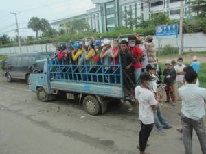 Loading onto one of dozens of trucks outside a garment factory at home time