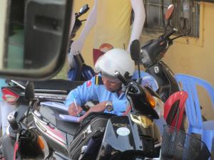 Despite many evaders, this guy was kept busy writing receipts and placing loose notes into his bag, paid by those who chose not to evade the fine!